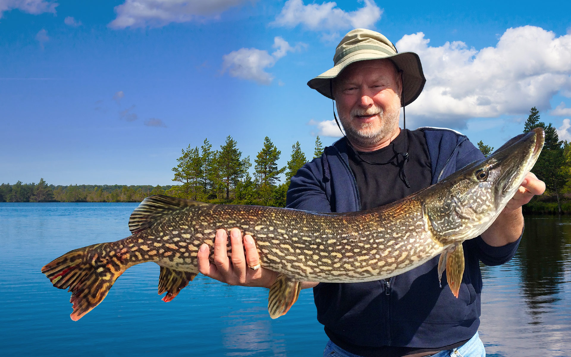 Fisherman Holding Huge Pike he Caught on Rowdy Lake